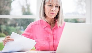 Senior business lady working through papers prepaid funeral plans