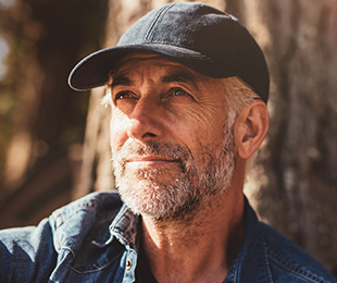 handsome senior man smiling prepaid funeral plans pros and cons