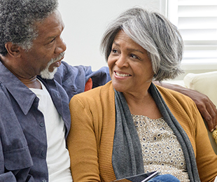 happy senior couple teasing each other funeral insurance plans