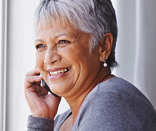 happy senior woman on a phone call funeral plans for over 50s