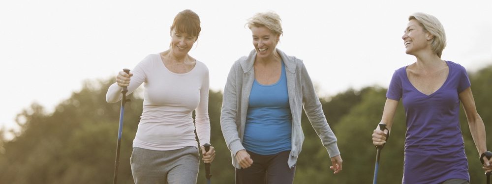 Three ladies walking and chatting funeral plans uk