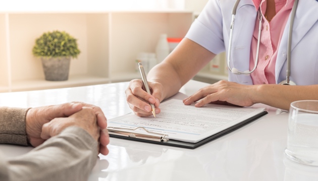 Someone signing a contract funeral care plan