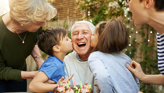 Grandfather being kissed on either cheek by two grandchildren funeral planning